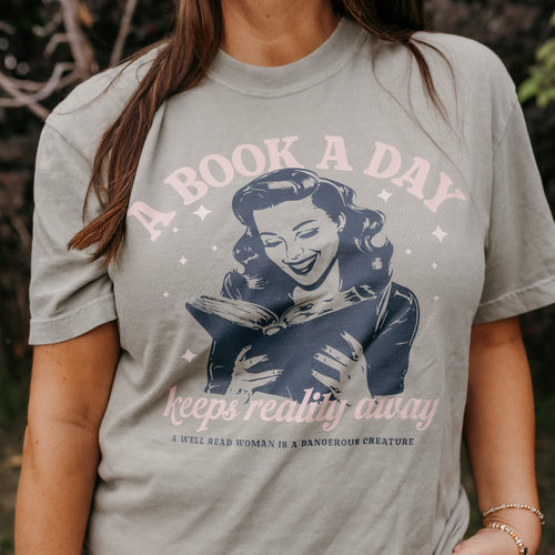 A Book A Day Keeps Reality Away - Comfort Colors Tee